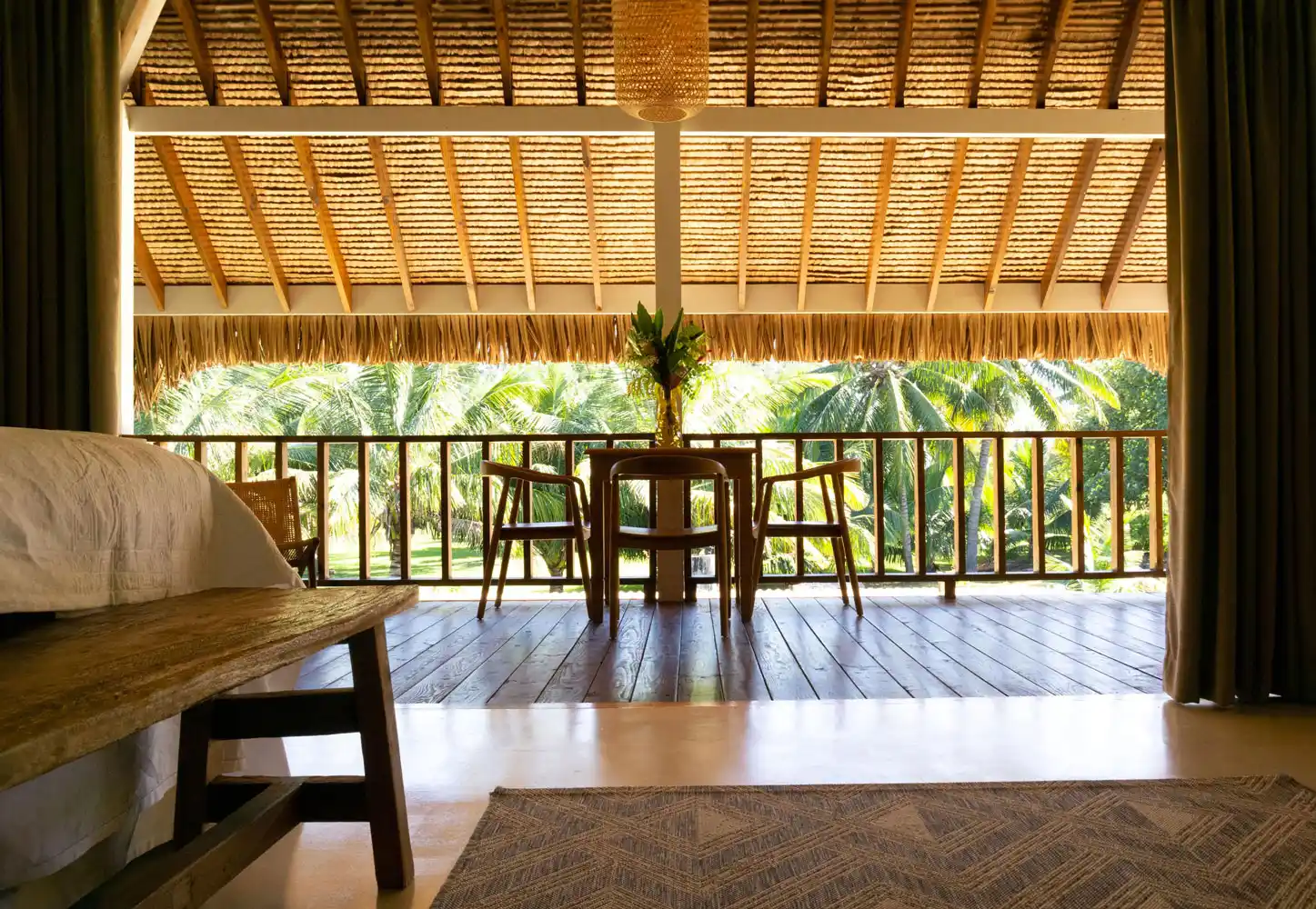 Soothing view from the bedroom onto the lush outdoor terrace, immersed in the tropical greenery of Fare Kautinaki at Fare Tiaia.